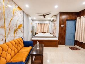 a living room with a bed and a couch at Ankita Guest House Dankuni in Khorel