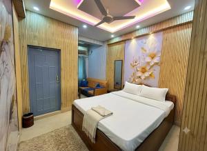 a bedroom with a bed with a flower painting on the wall at Ankita Guest House Dankuni in Khorel