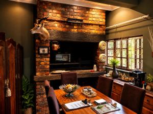 a dining room with a table with a deer head on the wall at Moonriver Guesthouse in Upington