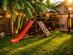 a red slide in the yard of a house at Moonriver Guesthouse in Upington