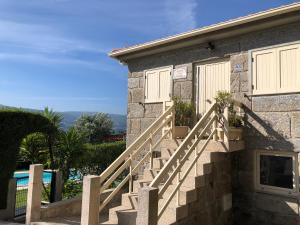 a stone building with stairs next to a pool at Charming Villa in Resende with Private Pool in Resende