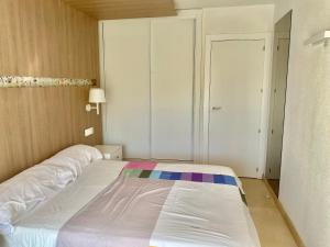 a bedroom with a large white bed in a room at Modern Apartment in Salou - 50 m² + Pool in Salou +57 photos