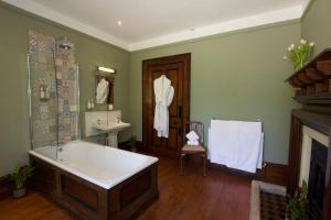 a bathroom with a bath tub and a sink at Costislost House in Wadebridge +44 photos