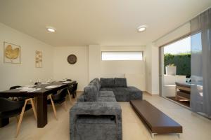 a living room with a couch and a table at The peaceful escape with shared pool in Porto Rafti