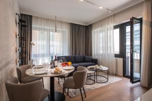 a living room with a table and a couch at Boutique Suites in Lugano