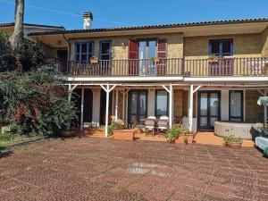a large house with a patio and a balcony at Welcoming Apartment in Fabrica di Roma – 140 sqm, Private Pool in Fabrica di Roma