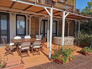 a patio with a wooden pergola and a table and chairs at Welcoming Apartment in Fabrica di Roma – 140 sqm, Private Pool in Fabrica di Roma