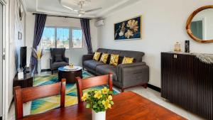 a living room with a couch and a table at City Getaway Apartment in Zanzibar City