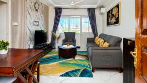 a living room with a couch and a table at City Getaway Apartment in Zanzibar City +6 photos