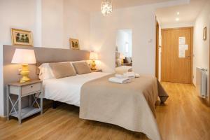 a bedroom with two beds and a table with a lamp at Charming Studio with Mountain View in Arinsal - 40m² in Arinsal