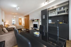 a living room with a couch and a table at Charming Studio with Mountain View in Arinsal - 40m² in Arinsal