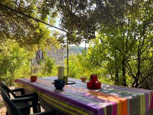 a table with a colorful table cloth on it at Maison charmante à Valleraugue avec piscine partagée. in Valleraugue
