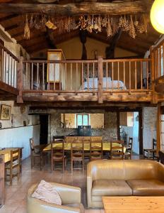 a living room with a table and a loft at Maison charmante à Valleraugue avec piscine partagée. in Valleraugue