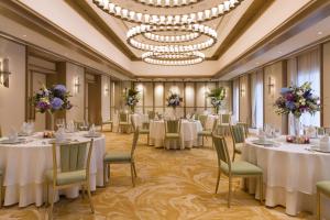 a banquet room with tables and chairs and a chandelier at DLF Club 4 in Gurgaon