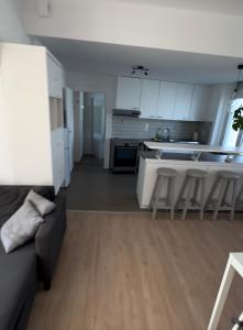 a kitchen and living room with a couch and a table at la casa de gege in Mellet