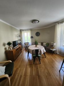 a living room with a table and a couch at La Tour Cicon in Salins-les-Bains