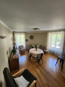 a living room with a table and a couch at La Tour Cicon in Salins-les-Bains