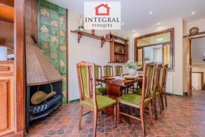 a dining room with a table and chairs and a fireplace at Casa Terral in Palamós
