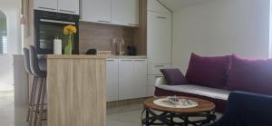a living room with a couch and a table at Fine Rest- City Center Apartment in Brčko