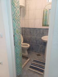 a bathroom with a toilet and a sink at Tina Rooms in Ulcinj +31 photos