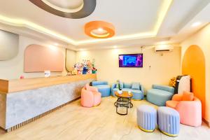 a waiting room with chairs and a counter at SANS Hotel Joy Inn Brebes in Ketanggungan