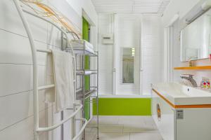 a bathroom with a sink and a towel rack at Bungalow charmant à Rivière-Salée avec terrasse privée in Rivière-Salée +14 photos