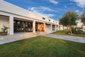 an exterior view of a house with a yard at Karoo Retreat- Self Catering Villas and Guest House in Oudtshoorn