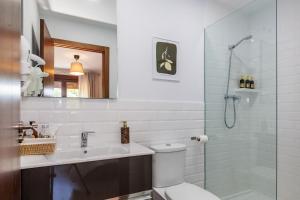 a bathroom with a toilet and a sink and a shower at La Casona de Omaña in Fasgar +88 photos