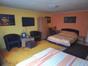 a hotel room with two beds and a television at Modern&Cozy Bosnian house with GARDEN+FREE parking in Sarajevo
