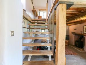 a spiral staircase in a home with wooden steps at The Brew House in Penrith