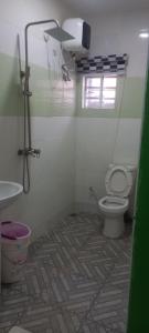 a bathroom with a toilet and a sink at PAUL's PLACE in Loburo
