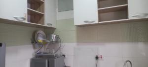 a kitchen with white walls and a sink at PAUL's PLACE in Loburo +14 photos
