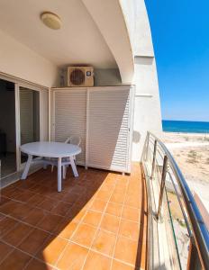 a balcony with a table and a view of the beach at Comfortable Apartment with Sea View – Hergla – 75 m² in Harqalah