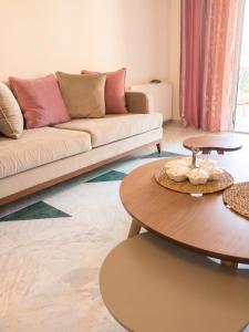 a living room with a couch and a table at Comfortable Apartment with Sea View – Hergla – 75 m² in Harqalah
