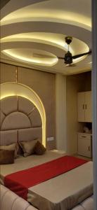 a bedroom with a large bed with a ceiling at Cube Stay in Bhopal