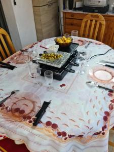 a table with wine glasses and food on it at Maison accueillante à Leucate avec jardin et terrasse in Leucate