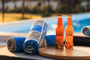 two bottles of hot sauce sitting on a table at Karoo Retreat- Self Catering Villas and Guest House in Oudtshoorn