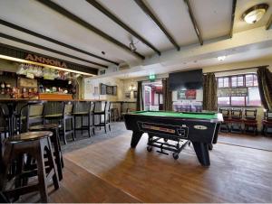 a pool table in a room with a bar at ANNORA Bar & Accommodation in Portnoo +30 photos
