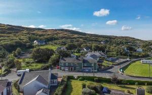 an aerial view of a small village in the hills at ANNORA Bar & Accommodation in Portnoo