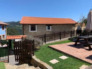 a wooden fence in front of a house with a picnic table at Charming house in Biescas with shared pool in Biescas