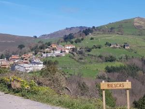a sign on the side of a road near a village at Charming house in Biescas with shared pool in Biescas