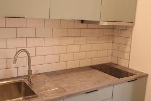 a kitchen with a sink and a counter top at Gaia River View in Vila Nova de Gaia