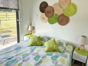 a bedroom with a bed and some hats on the wall at Maison cosy à La Bouillie + jardin in La Bouillie
