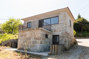 a stone house with a balcony on the side of it at Idyllic Villa in Fornos + Pool! in Fornos +55 photos