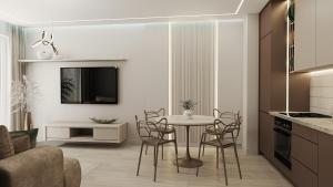 a kitchen and living room with a table and chairs at Apartamenty Kościuszki Winda Klimatyzacja in Iława