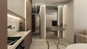 a kitchen with a counter and a dining room at Apartamenty Kościuszki Winda Klimatyzacja in Iława +1 photo