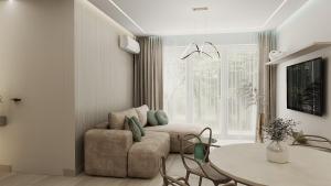 a living room with a couch and a table at Apartamenty Kościuszki Winda Klimatyzacja in Iława