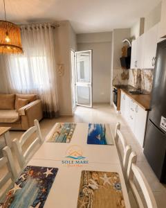 a kitchen with a table with a sign on it at Sole Mare - Beach House in Kavajë