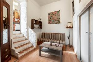 a living room with a couch and a table at Appartement cocooning à Barrême, 30 m² avec balcon in Barrême +12 photos