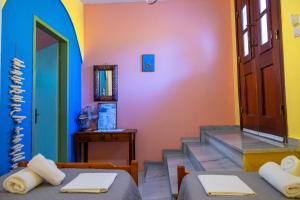 a room with two beds and a staircase with a door at Symi Garden Studios in Symi +139 photos